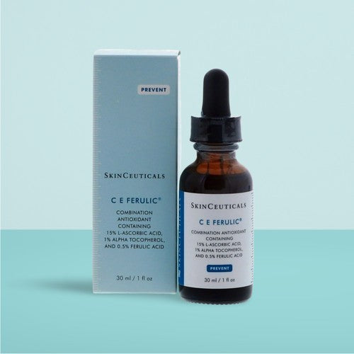 SkinCeuticals C E Ferulic skincare product with dropper and packaging on a light blue background